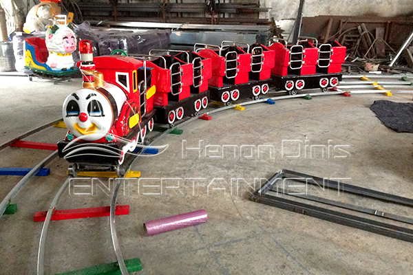 circus train ride with track for little children in amusement parks